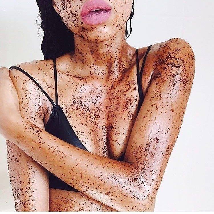 woman applying coffee scrub her whole body for smooth skin 
